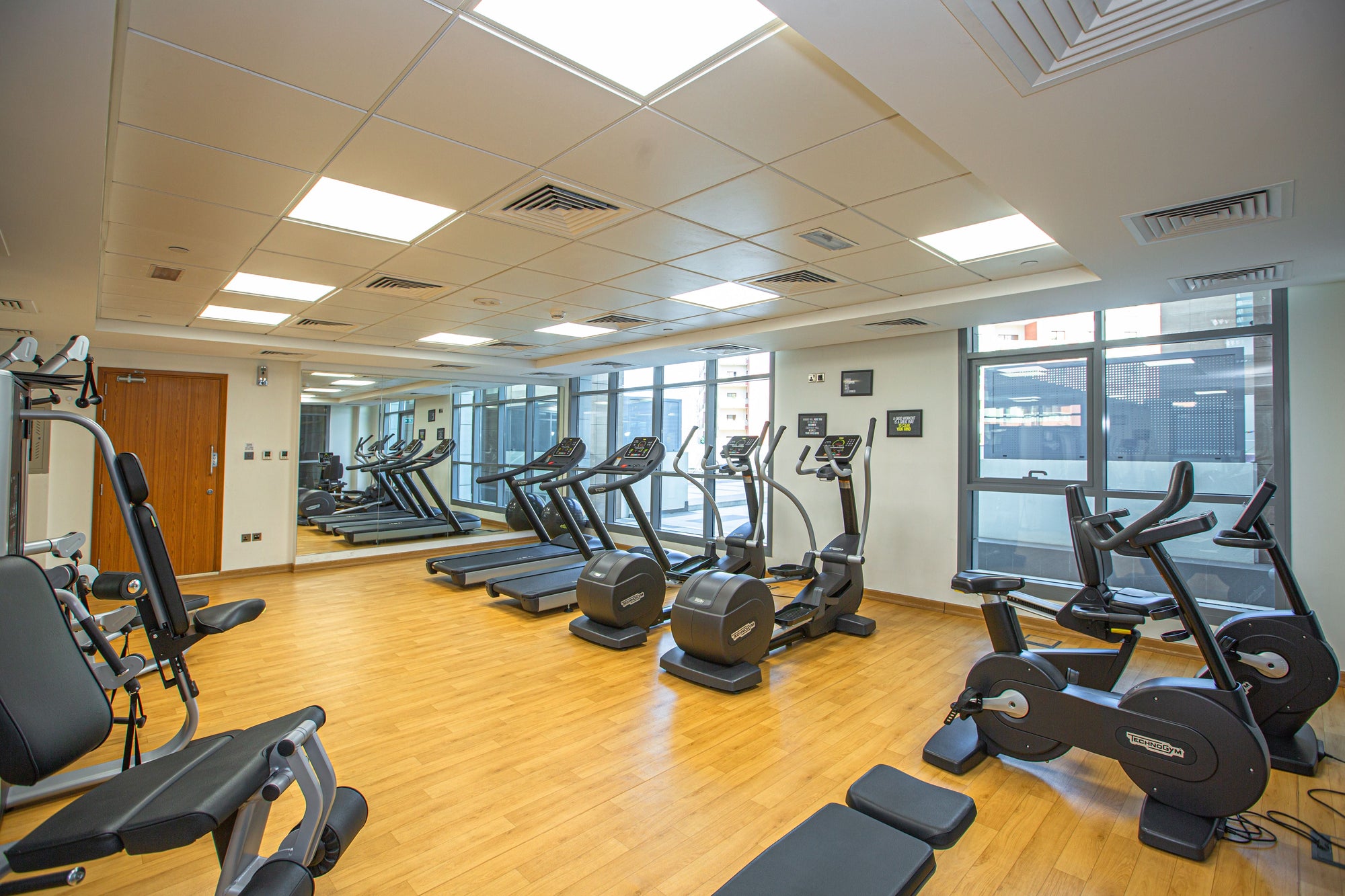 Hotel fitness facility with cardio equipment and natural light