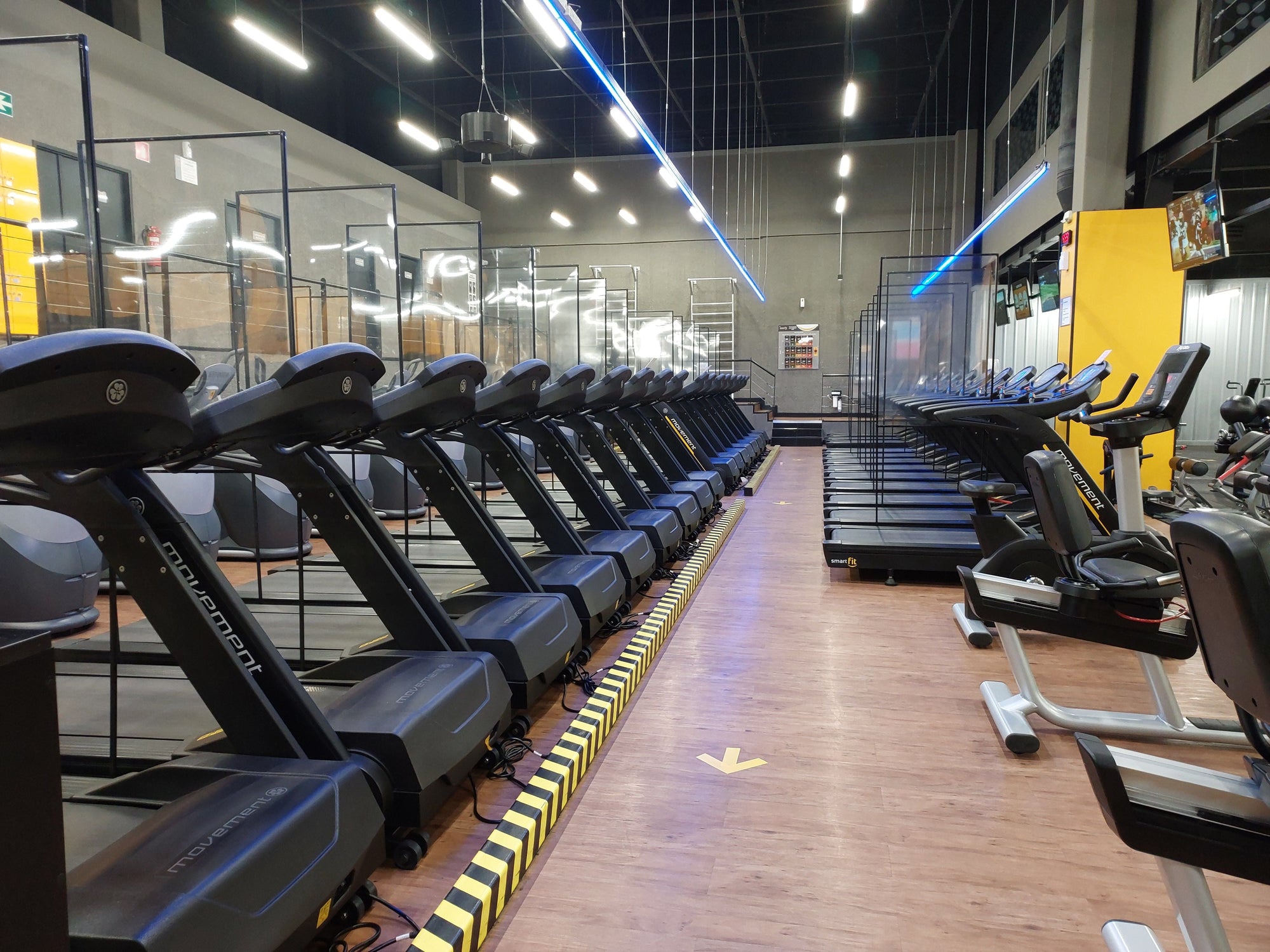 Row of commercial treadmills on a gym floor under an annual maintenance contract