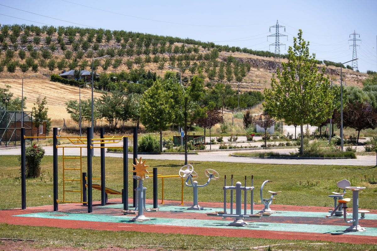 Outdoor fitness equipment installed in a landscaped community park