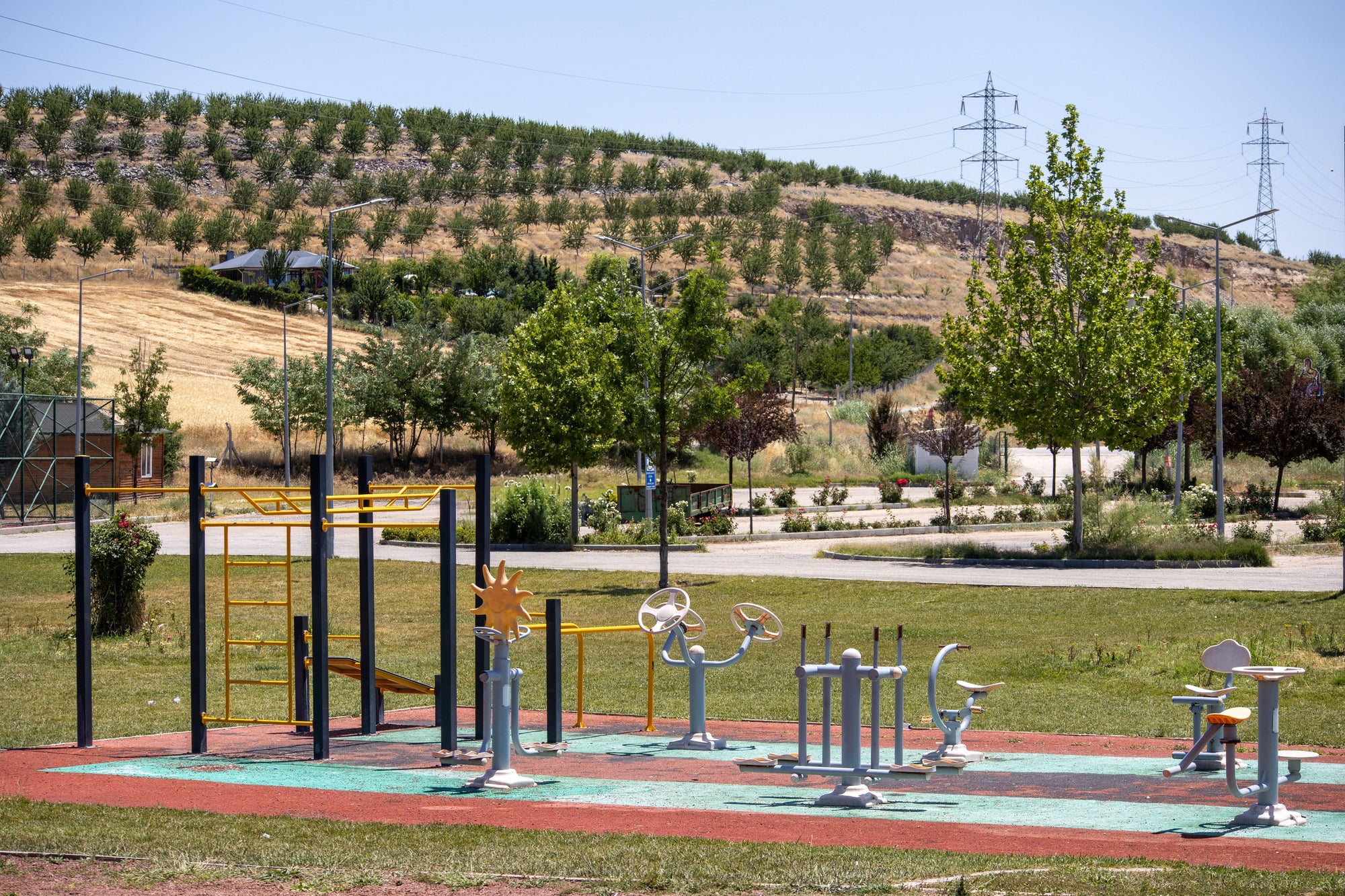 Outdoor fitness equipment installed in a landscaped community park